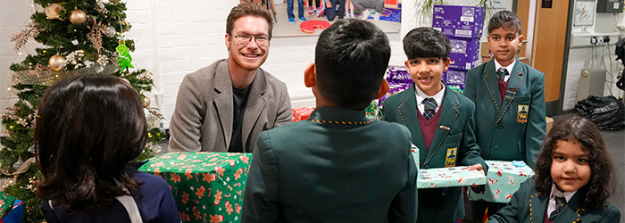 Adopted brothers make festive donation to city children